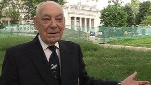 Ted Cachart in front of the memorial