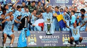 Manchester City players celebrate with the Barclays Premier League trophy