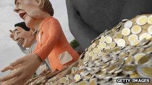 A mannequin of German Chancellor Angela Merkel stands outside her offices in Berlin, 27 June