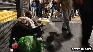 A man busks in the streets as young Mexicans go home after a political demonstration in Mexico City's main square on 23 June 2012