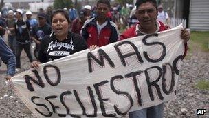 Migrants and activists carrying a banner reading "No more kidnappings" walk towards City Hall to protest against violence of migrants and to demand a shelter for migrants, in Lecheria, Mexico, Thursday, 17 May 2012