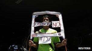 student from the anti-PRI youth opposition movement "Yosoy132" (I am 132) holds a mock TV during a protest at the facilities of telecoms regulator Cofetel