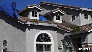 A vacant home has weeds growing in the gutters in the Weston Ranch neighbourhood of Stockton, California in this 6 March 2012