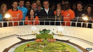 Danny Boyle (centre) with Olympic volunteers and a model of the "British countryside" set