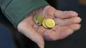 An older person holding some money