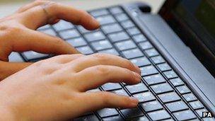 A person uses a laptop keyboard