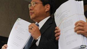 Albert Ho displaying court papers to the press on 5 July 2012