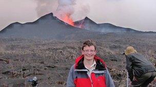 Dr Lorraine Field in front of the erupting Nyamuragira volcano