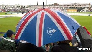 Spectators shelter from the rain at Edgbaston, 4 July