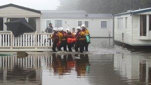 Lifeboat crews are helping people from a caravan at Cayton Bay caravan park in North Yorkshire