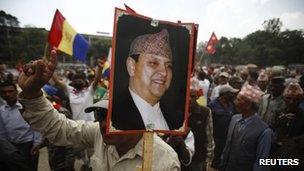 Supporter carries a poster of the former king in Kathmandu in June 2012