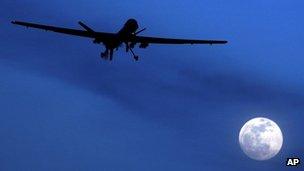 A US RQ-1 Predator drone or UAV (Unmanned aerial vehicle) flies over the moon above Kandahar Air Field, southern Afghanistan