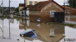 A submerged car in a flooded street in a village near Krymsk. Photo: 7 July 2012