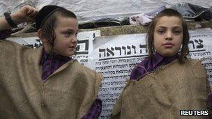 Ultra-Orthodox Jewish boys wear sacks, a symbol of mourning, during a protest against the new conscription proposal. Photo: June 2012