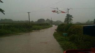 Helicopter over floodwater