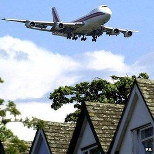 Airliner descending over houses