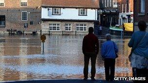 People watching rising water of River Ouse in York