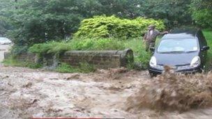 Flood water running down a road in Hebden Bridge