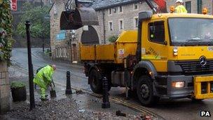 Workers clearing rubble at Hebden Bridge