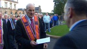 Orangemen handed a letter of protest over Crumlin to a representative of Owen Paterson