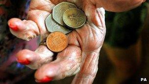 Older person holding coins