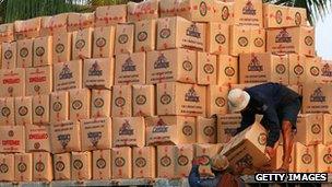 Workers load boxes of goods at the harbour in Rangoon