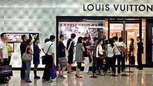 Chinese customers queue outside a Louis Vuitton store in Shanghai