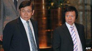 In this file picture taken on 3 April, 2012, Raymond Kwok (L) and Thomas Kwok (R) walk towards a press conference in Hong Kong