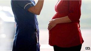 Pregnant woman talking to a nurse