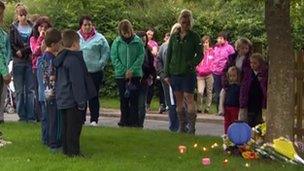 Parents and children attend a vigil for the family in Coleford