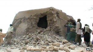 A still from a video shows Islamist militants destroying an ancient shrine in Timbuktu on July 1, 2012