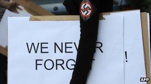 Woman wearing anti-Nazi badge and carrying banner in Budapest, (16 July 2012)