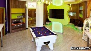 A recreation room with pool table