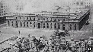 Soldiers supporting the coup led by Gen Augusto Pinochet take cover as bombs are dropped on the Presidential Palace of La Moneda in this 11 September 1973 file photo