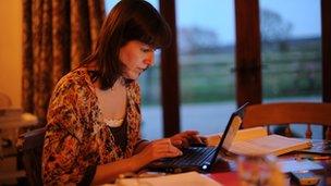 Generic image of a woman using a laptop at home