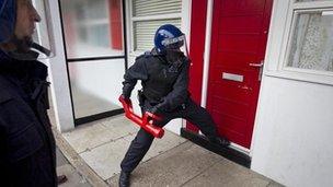 Generic police breaking down door