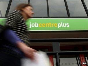 Woman walks past a Job Centre