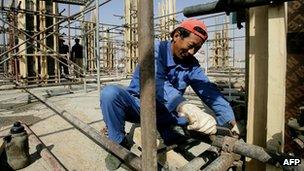 A Chinese worker fixes pipes at a construction site in Khartoum, Sudan