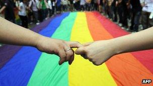 Gay and lesbian activists march with a rainbow flag in Hong Kong (file photo)