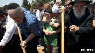 Family and friends mourn as Kochava Shriki, 44, who was killed in an attack in Bulgaria, is buried at a cemetery in Rishon Lezion, near Tel Aviv July 20, 2012