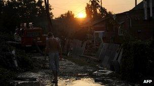 A local resident walks along a flooded street in the southern Russian town of Krymsk on 8 July