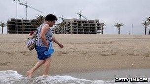 Woman walks along Almeria beach