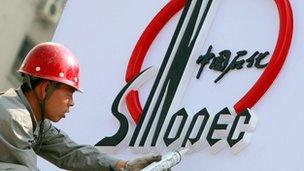 Man working on Sinopec sign