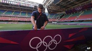 Worker sets up Olympic billboard at the Millennium stadium