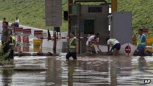 Workers in Beijing's Fangshan district dealing with the aftermath of the heaviest rain in six decades