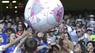 Fans play with a huge ball inside the Millennium Stadium