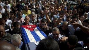 Friends and family of Cuban activist Oswaldo Paya carry his coffin during his burial at a cemetery in Havana