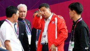 North Korean Women's football team staff member talks to officials at Hampden Park