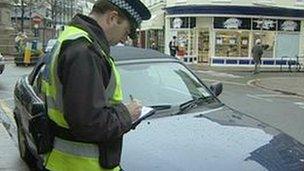 Traffic Warden writing a ticket