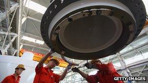 Workers at an equipment making factory in China